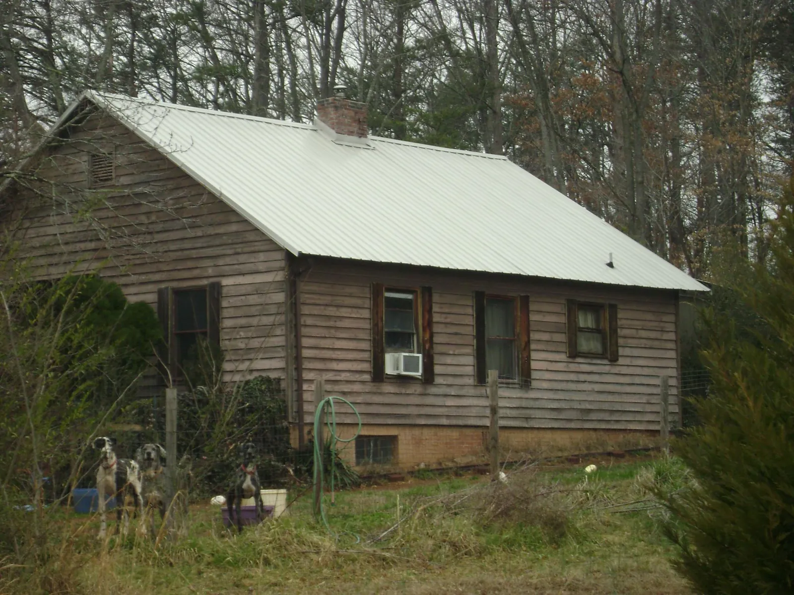 White metal roof on an old wood sided farmhouse, from a Metal Roof Installation job in Kingstree
